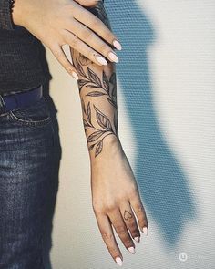 a woman's arm with a tattoo on it and her hand in the air