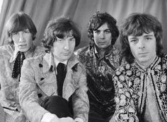 the rolling stones posing for a black and white photo