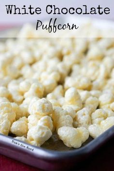 white chocolate popcorn in a metal pan on a red tablecloth with text overlay