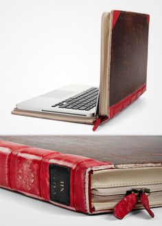 an open laptop computer sitting on top of a red leather book with the cover opened