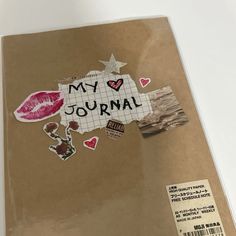 a book with stickers on it and the words'my journal'written in different languages