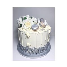 a white cake with flowers and seashells on top