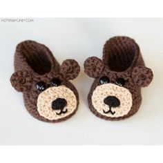 a pair of crocheted baby shoes with a bear face on the front and bottom