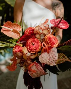 a woman holding a bouquet of flowers in her hands