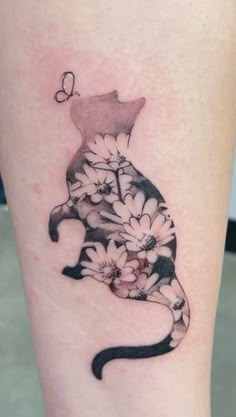 a black and white cat with flowers on it's leg