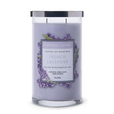 a candle with lavender flowers on the front and side, in a glass container that says french lavender