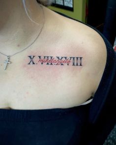 a woman with a cross on her chest has a tattoo that reads x, y and all