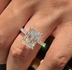 a woman's hand with a diamond ring on it