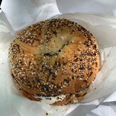 a bagel covered in sesame seeds and cheese