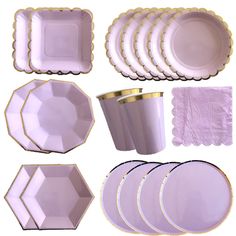 a bunch of plates that are sitting on a white tablecloths set up in the shape of hexagonal shapes