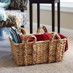 a wicker basket filled with books on the floor