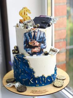 a white and blue cake with money on top