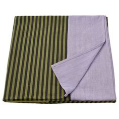 two pieces of purple and green striped fabric on top of each other, one folded in half