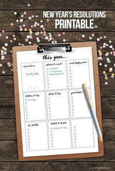 a new year's resolution printable on a clipboard with confetti