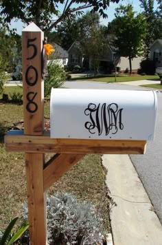 a mailbox with the word monogrammed on it in front of a house