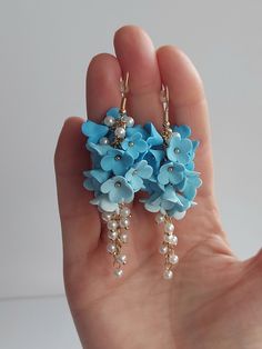 https://purplebeestudio.etsy.com Handmade unique polymer clay chandelier earrings in sky blue colour. The polymer clay flowers are made by me without using any molds. These very elegant earrings will become your favorits for many occasions day or night. Earrings made with brass ear wire. The earrings are very light and comfortable to wear all day. SHIPPING: Your order will be dispatched in a securely packed cardboard box. Product care:  - To ensure the product quality and durablility, avoid contact with water, lotion, perfumes and household cleaners and chemicals. - You can clean the products with a slightly damp soft fabric.  - Sharp objects can damage the clay surface. - When not in use, store in a dry, seperate box. Thank you for visiting my shop! If you have any special requests, I'll Clay Chandelier, Sky Blue Earrings, Sky Blue Colour, Paper Jewellery, Handmade Clay Jewelry, Handmade Jewel, Floral Jewelry, Earrings Bridesmaid, Handmade Gifts For Her