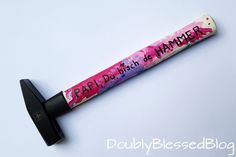 a pink and purple tube with writing on it sitting on top of a black object