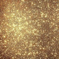 gold glitter sparkles in the air with lots of small dots on it's surface