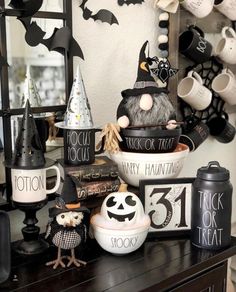 halloween decorations are displayed on a dresser in front of a mirror