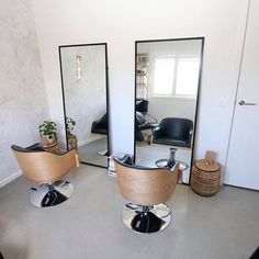 a hair salon with mirrors and chairs on the floor next to each other in front of a door