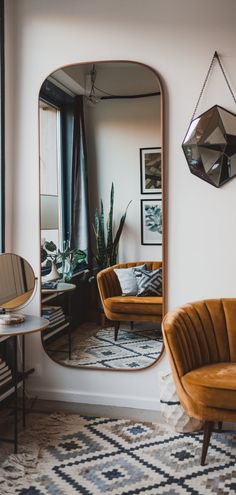 a living room filled with furniture and a large mirror