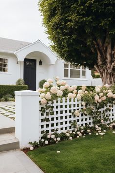 a white picket fence with roses growing on it