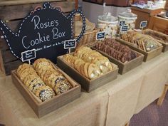 there are many different types of cookies in the box on display at this market stall