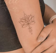 a woman's arm with a small tattoo on the left side of her body