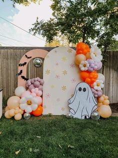 an outdoor halloween party with balloons and decorations