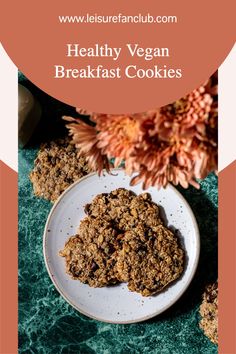 healthy vegan breakfast cookies on a plate with flowers in the background and text overlay that reads, healthy vegan breakfast cookies