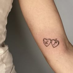 a couple of hearts tattoo on the arm