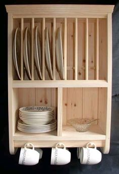 a wooden shelf filled with plates and cups