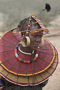 an african woman in traditional headdress and jewelry