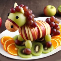 a horse made out of fruit sitting on top of a plate