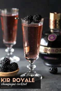 two glasses filled with liquid and blackberries