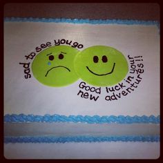 two green smiley faces on top of a sheet cake with words that say good luck and new adventures