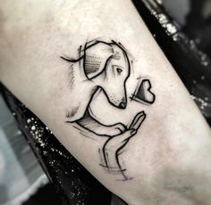 an elephant holding a heart tattoo on the arm