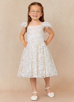 Delia is our adorable flower girl dress crafted from tulle and lace. She features a straight neckline with gathered sleeves. The look is complete with a knee length A-line skirt and a bow tie back. Delia Flower, Champagne Flower Girl, Long Flower Girl Dresses, Formal Wedding Guests, White Champagne, White Flower Girl Dresses, Flower Girl Dresses Tulle, Bridal Party Dresses, Custom Size Dresses