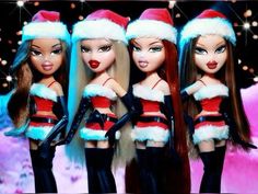 three dolls dressed in santa hats and black stockings are standing next to each other with their hands on their hips