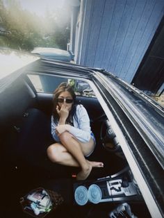 a woman sitting in the back seat of a car