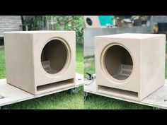 two concrete speakers sitting in the grass