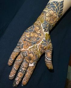 a woman's hand is decorated with hennap and flower designs on it