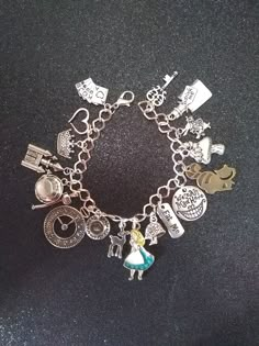 "Silver tone plated metal bracelet with lobster clasp ** 8\" length ** Links are 8×7mm and can easily be adjusted with beading pliers. 17 total charms are lead and nickel free. Zinc alloy metal Charm vary in size:  Alice for example is 33×18mm and the rabbit is 20×15mm Alice charm is gold plated with enamel coloring and the Heart charm is rose gold in color. Cat is antiqued bronze Weighs 1.15oz Great gift for any Alice in wonderland enthusiast. Super cute and full of magic No returns or exchange Metal Charm Bracelet, Alice In Wonderland Merch, Charm Bracelet Aesthetic, Alice In Wonderland Bracelet, Beads Business, James Avery Charm Bracelet, Random Jewelry, Custom Gold Jewelry, Charm Ideas