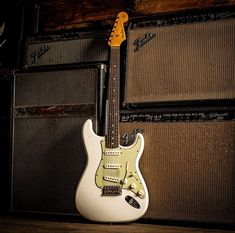 an electric guitar sitting on top of a wooden floor