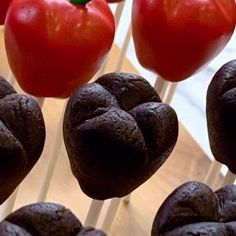 some chocolate cookies and tomatoes on sticks