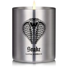 a candle that is sitting in front of a metal container with the words snake on it