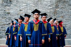 a group of men standing next to each other in graduation gowns