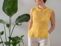 "The most adorable vintage open weave crochet top from the 1960s in stunning golden yellow colour. It seems to be a handmade piece. Open weave, sleeveless design with drawstring at waist. It features Peter Pan collar and side slits. Material: feels like cotton or a cotton blend (no tag) Condition: great vintage condition Size: best fits size XS-S, depending on desired fit (no size tag) Please compare measurements with a similar piece of your own before purchase. Measurements (taken while lying f Yellow Bohemian Sleeveless Crochet Top, 60s Crochet Top, Yellow Sleeveless Crochet Top, Yellow Crochet Sleeveless Top, Sleeveless Yellow Crochet Lace Top, Vintage Sleeveless Crochet Top, Yellow Sleeveless Crochet Lace Top, Yellow Retro Knit Top, Vintage Crochet Sleeveless Top