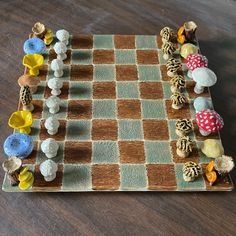 a chess board with several different colored pieces on it and one is made out of clay