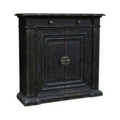 an old black wooden cabinet with two doors and knobs on the front, isolated against a white background